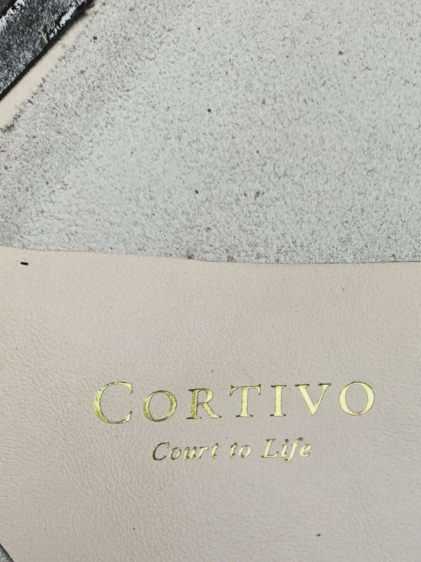 CORTIVO debossed gold stamp on leather